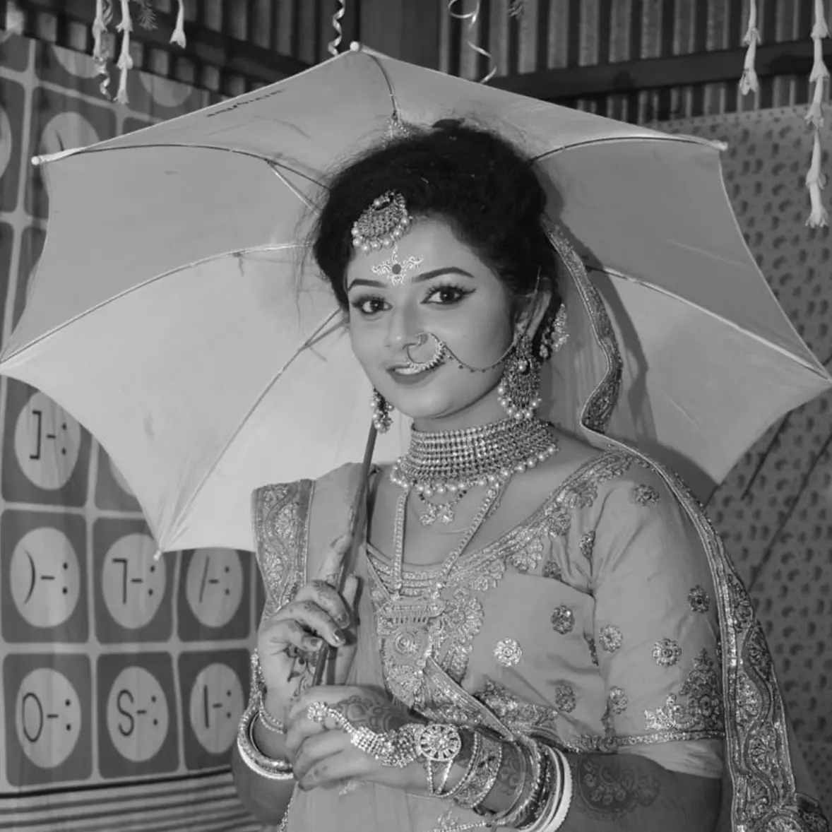 black & white image of a girl standing with umbrella